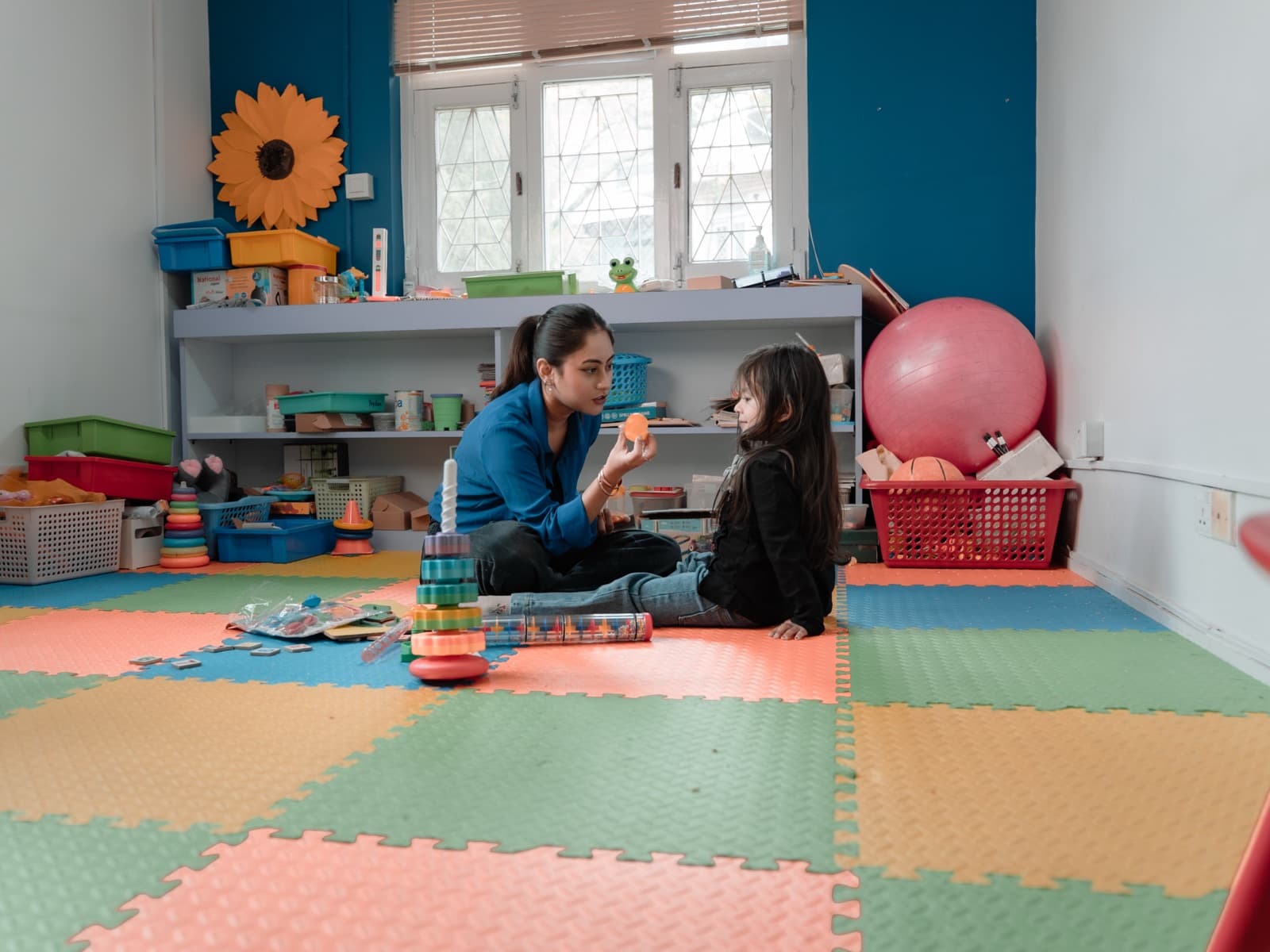 A therapist and child working together in a Sunflower therapy room